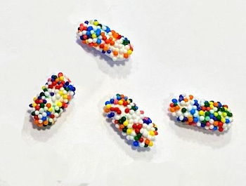 Pharmaceutical caplets coated with nonpareils.